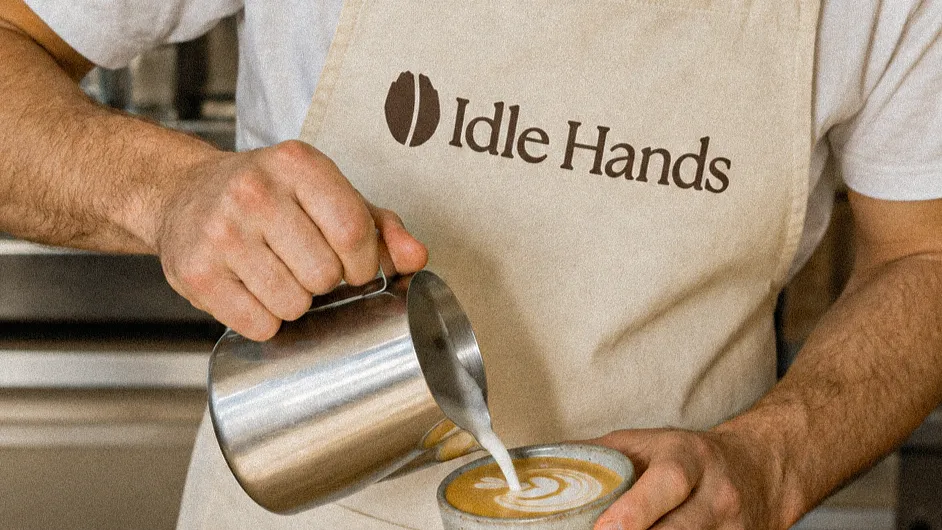 A pour at Idle Hands, apron and cap