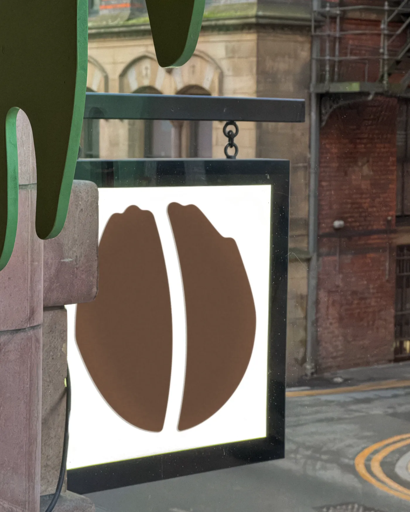 The Idle Hands bean logo on a hanging sign outside the Northern Quarter shop