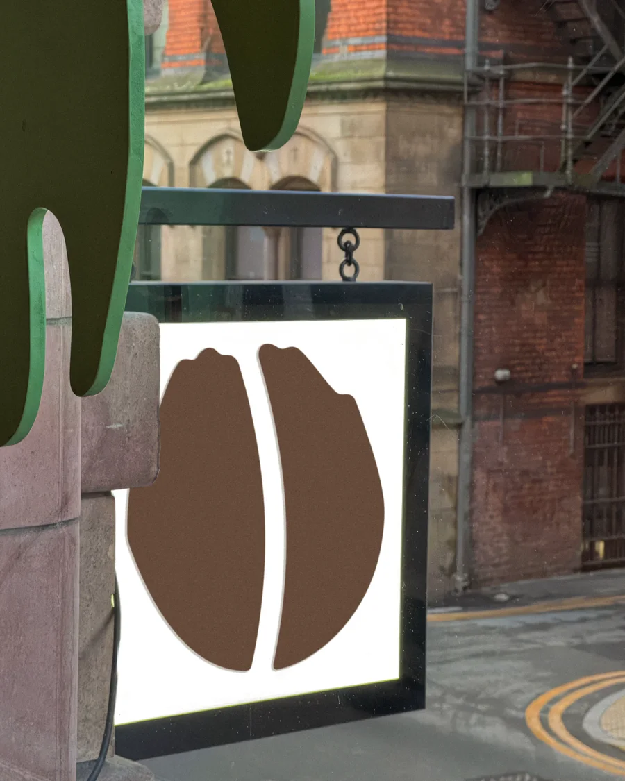 The Idle Hands bean-logo sign hanging outside the shop on the Dale Street corner